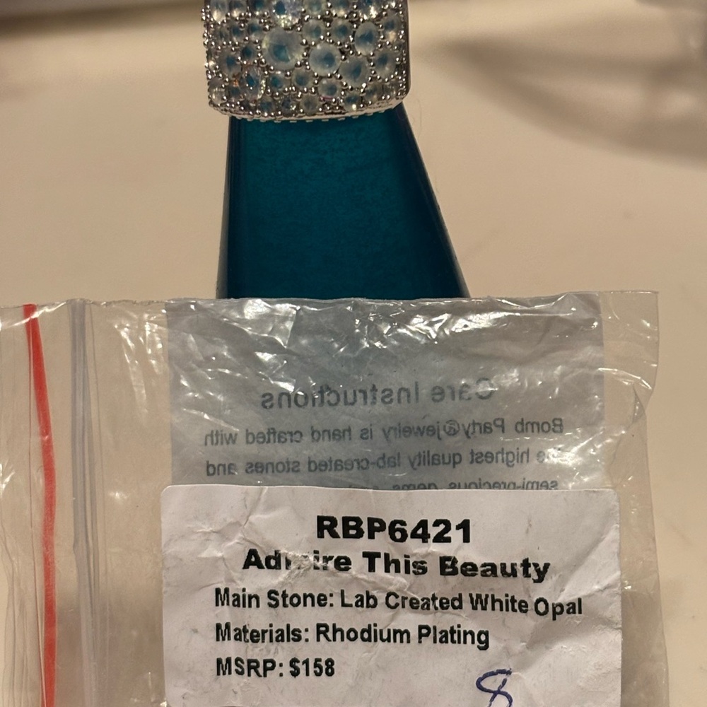 Adorned Blue Bottle with Silver Cap